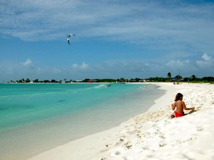 losroques-beach A little girl soaks up the sun on powdery sand in the Caribbean paradise of Los Roques, Venezuela. The keys in this archipelago have many different landscapes - from deserted islands to isles fringed by leafy mangroves.